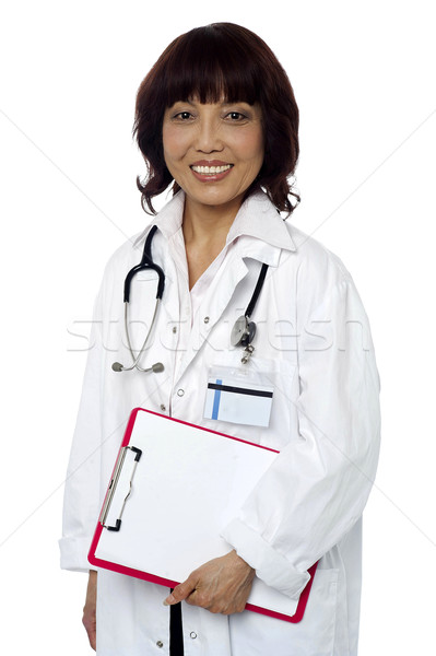 Medical expert holding clipboard. Ready to go... Stock photo © stockyimages