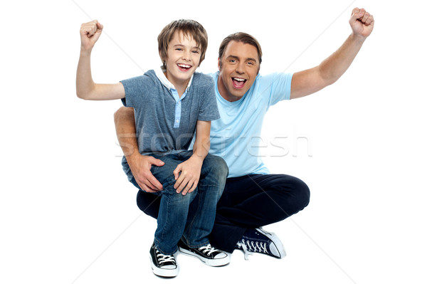 Joyous father and son cheering loud Stock photo © stockyimages