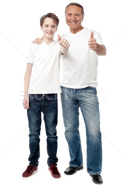 Smiling father and son showing thumps up Stock photo © stockyimages