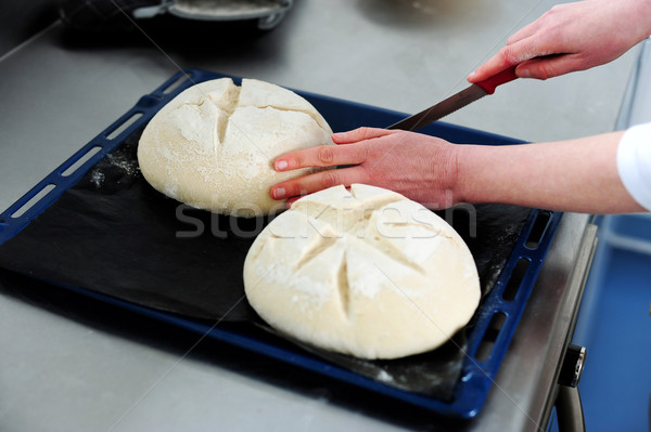 Female cutting dough in a creative manner Stock photo © stockyimages