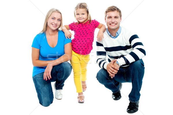 Trendy couple squatting with girl child in between Stock photo © stockyimages