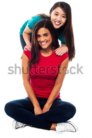 Młodych dziewcząt posiedzenia piętrze dwa Zdjęcia stock © stockyimages