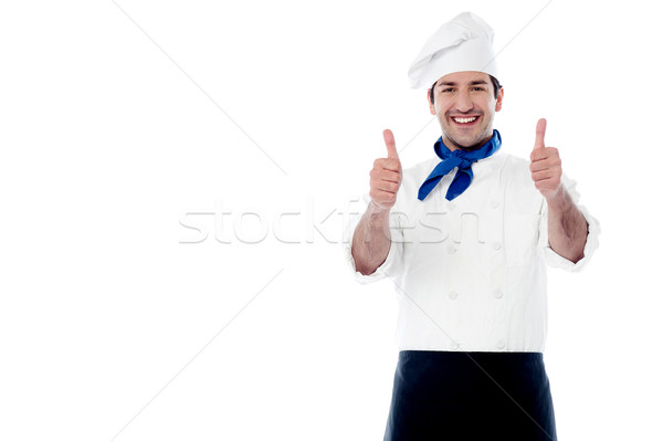 Smiling chef showing double thumbs up Stock photo © stockyimages