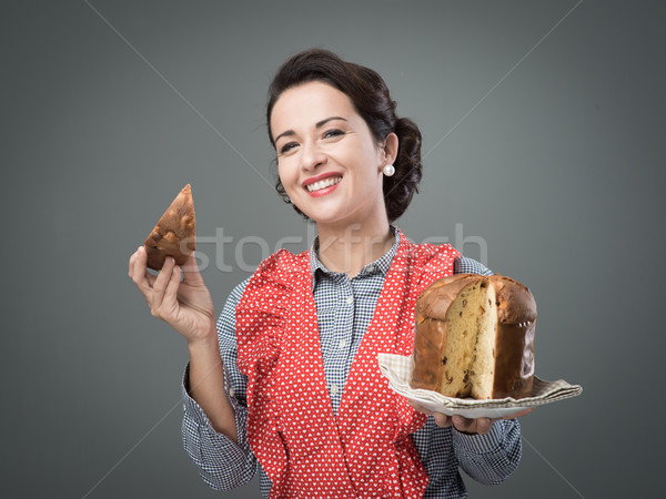 Woman in apron eating panettone Stock photo © stokkete