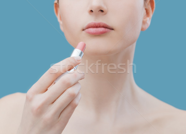 Woman applying lipstick Stock photo © stokkete