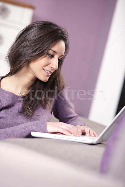 portrait of young woman on the sofa using laptop Stock photo © stokkete