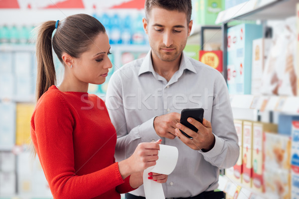 Couple shopping and checking a receipt Stock photo © stokkete
