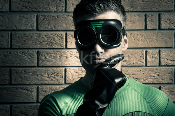 Confident superhero against a brick wall Stock photo © stokkete