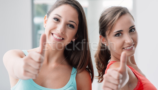 Cheerful girls thumbs up Stock photo © stokkete