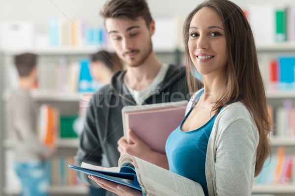 [[stock_photo]]: Heureux · élèves · bibliothèque · souriant · école