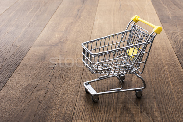 Miniature shopping cart on a desk Stock photo © stokkete