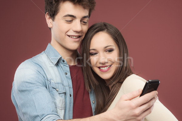 Young teen couple with smartphone Stock photo © stokkete