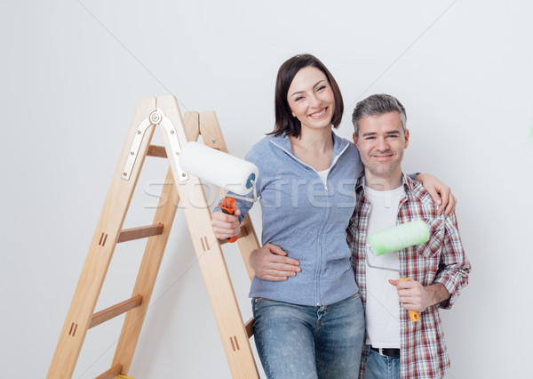 Happy couple renovating their home Stock photo © stokkete