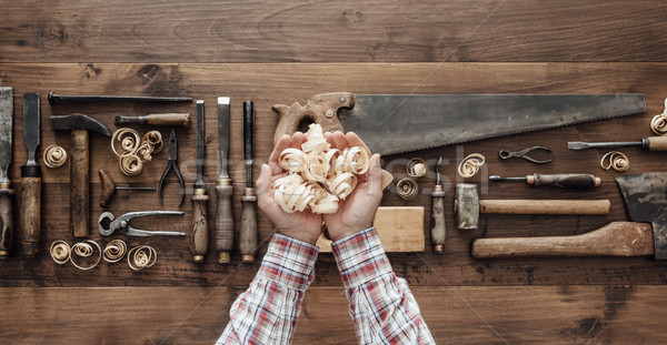 Carpenter holding wood shavings Stock photo © stokkete