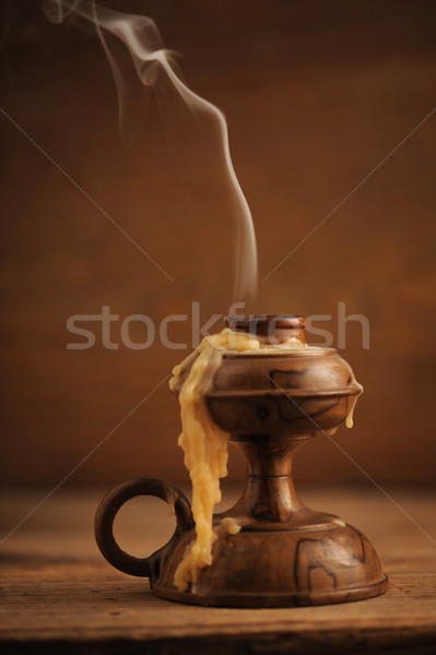 Stock photo: old candle on a wooden table