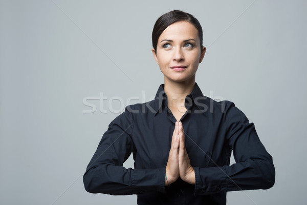 Smiling woman with hands clasped Stock photo © stokkete