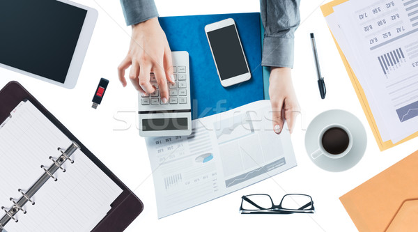 Business woman checking a financial report Stock photo © stokkete