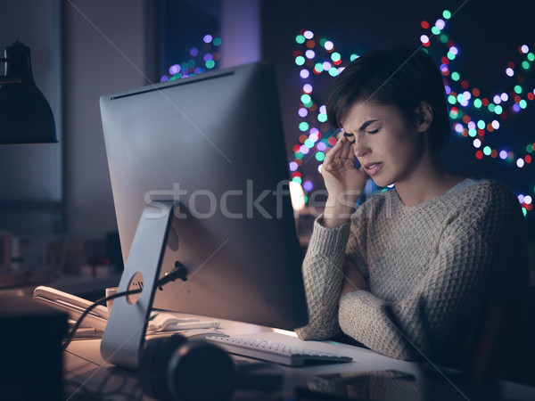 Stock photo: Woman having an headache late at night