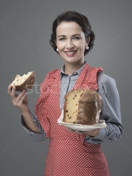 Woman in apron eating panettone Stock photo © stokkete