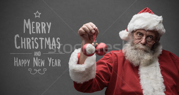 Lazy Santa Claus holding Christmas balls Stock photo © stokkete