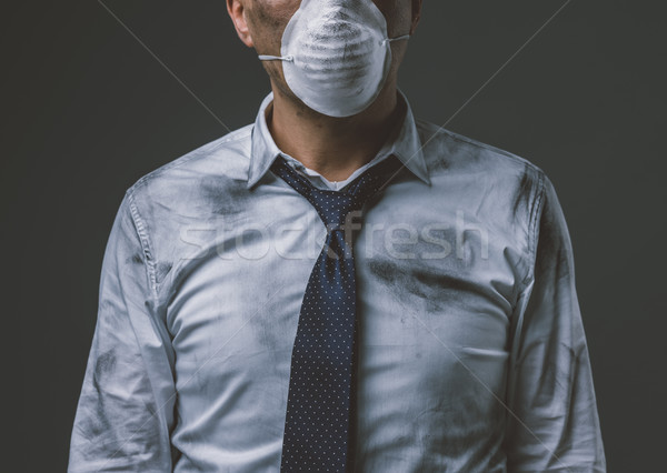 Businessman with mask and air pollution Stock photo © stokkete
