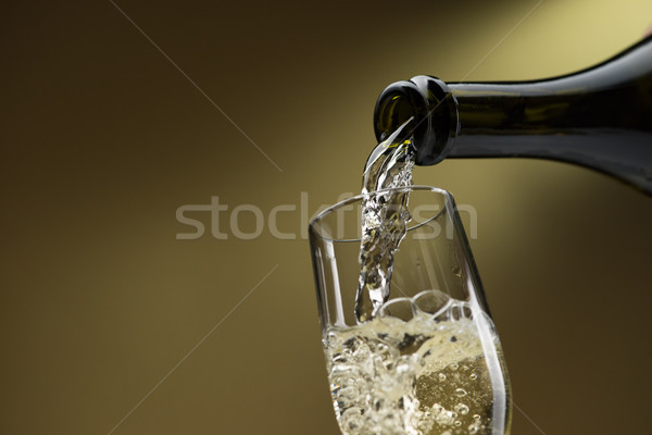 Pouring white wine into a wineglass Stock photo © stokkete