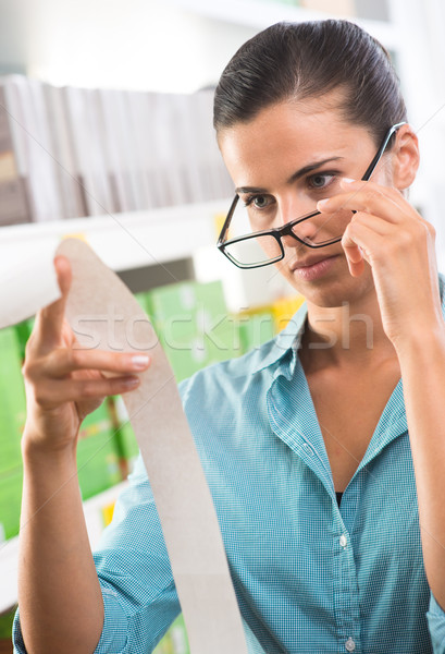 Woman with glasses checking a receipt Stock photo © stokkete