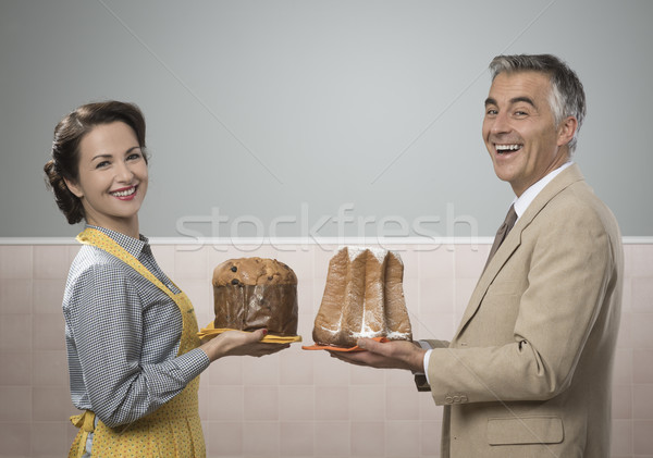 Smiling couple at home with christmas cakes Stock photo © stokkete