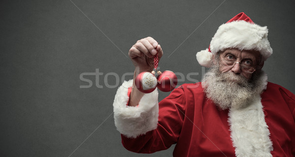 Lusta mikulás tart karácsony golyók kettő Stock fotó © stokkete