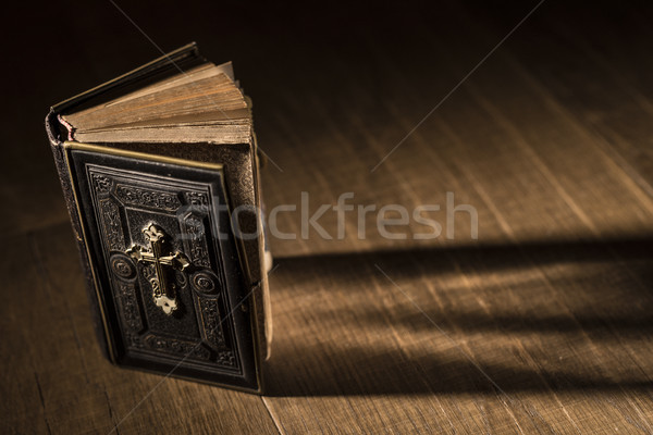Precious antique Bible on a wooden desktop Stock photo © stokkete