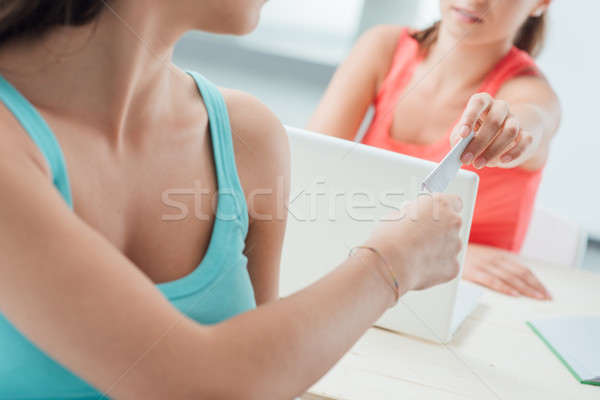 Stock photo: Girls passing a cheat sheet