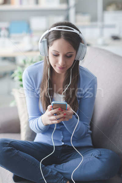 Girl listening to music with her smartphone Stock photo © stokkete