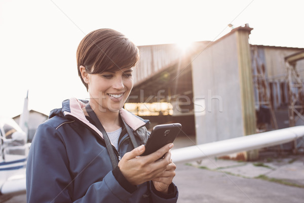 Smiling woman at the aerodrome Stock photo © stokkete
