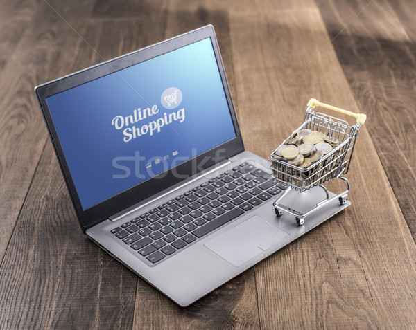 Foto stock: Carrinho · de · compras · completo · dinheiro · laptop · área · de · trabalho