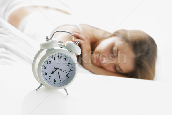 Genç kadın uyku genç bayan saat ön plan Stok fotoğraf © stokkete