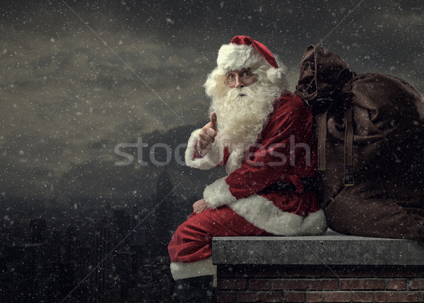 Santa bringing gifts on Christmas Eve Stock photo © stokkete