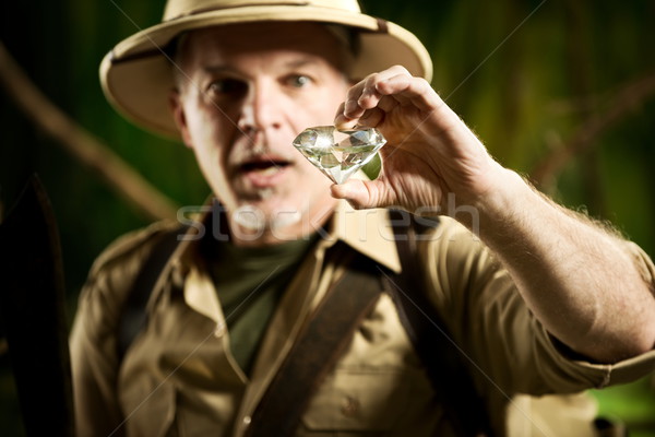 Stock photo: Explorer finding a huge gem in the jungle