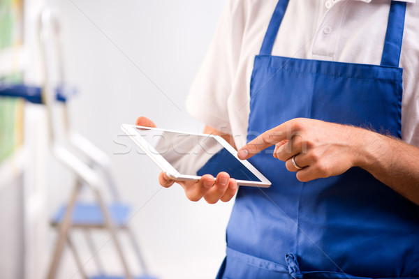Sales clerk using tablet Stock photo © stokkete