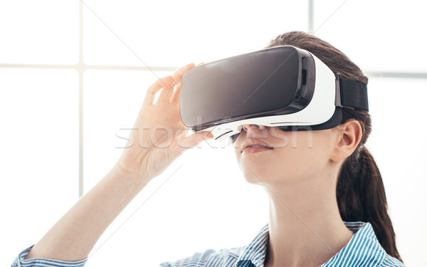 Stock photo: Young woman experiencing virtual reality