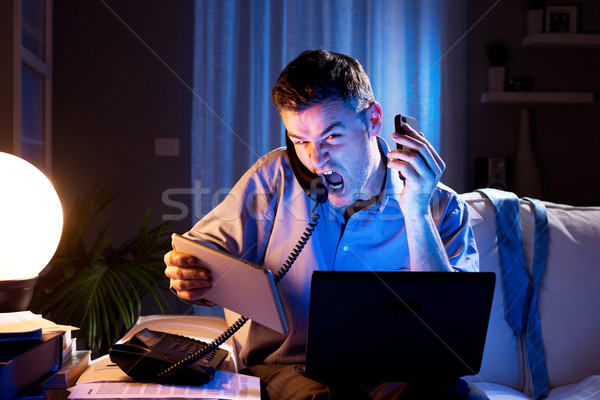 Businessman working overtime at home Stock photo © stokkete