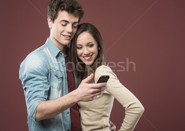 Young teen couple with smartphone Stock photo © stokkete