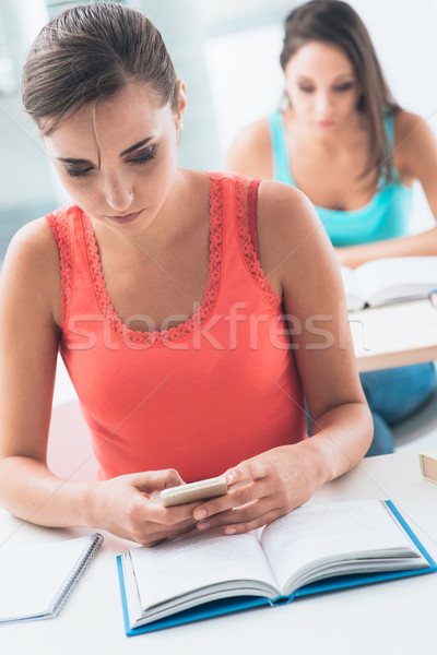 Teen girl at school using a mobile Stock photo © stokkete