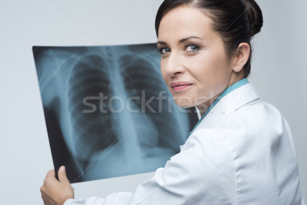 Stock photo: Female doctor examining x-ray image