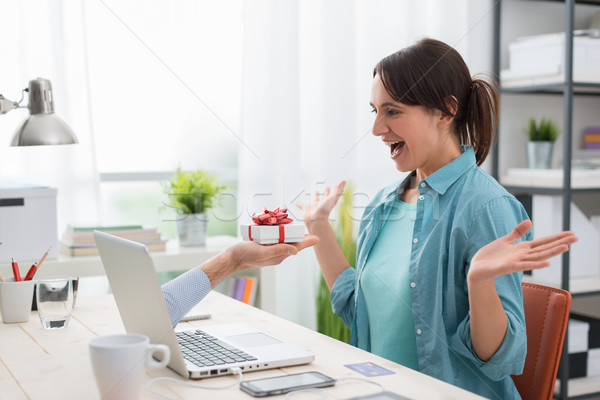 Woman receiving a gift from a website Stock photo © stokkete