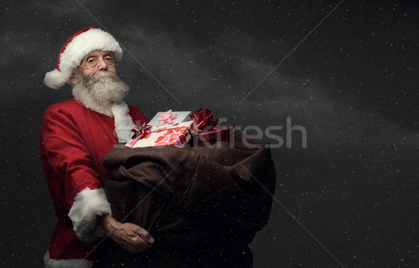 Santa Claus bringing gifts Stock photo © stokkete