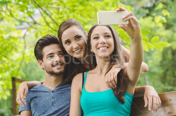 Cheerful teens at the park taking selfies Stock photo © stokkete