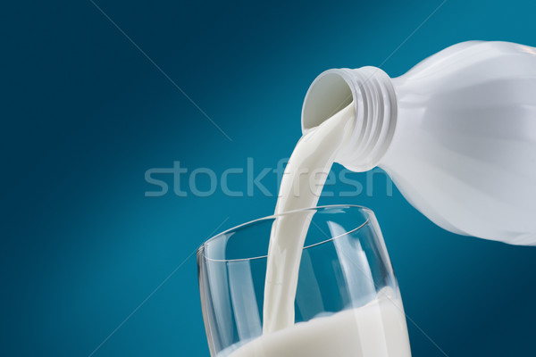 Pouring fresh milk into a glass Stock photo © stokkete