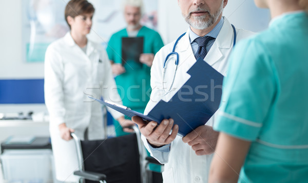Doctor examining a patient's medical records Stock photo © stokkete