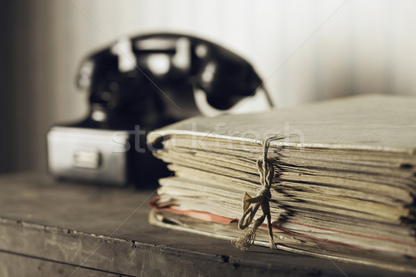 Old phone on a desk with documents Stock photo © stokkete