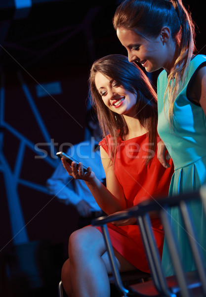 Two women enjoying with a smartphone Stock photo © stokkete